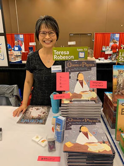 Teresa Robeson and a display of her books